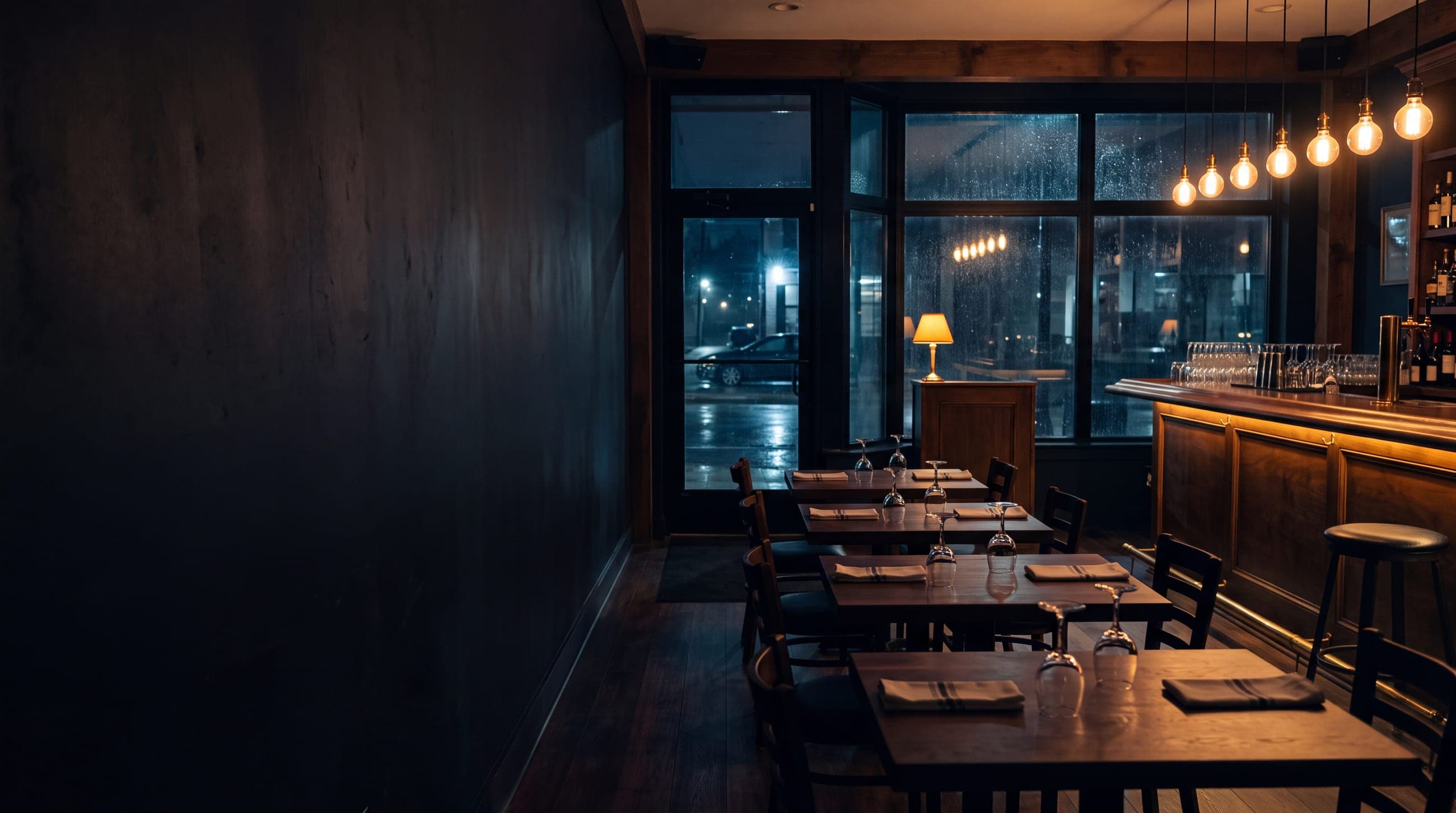 A restaurant owner plating at the pass while taking an order call mid-service